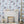 Carousel wallpaper by Brand McKenzie in blue, carousel animals on poles beside a fireplace