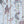 Carousel wallpaper by Brand McKenzie in blue, pattern detail of carousel animals on poles