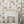 Carousel wallpaper by Brand McKenzie in cream, carousel animals on poles around a fireplace