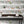 Catwalk wallpaper by Brand McKenzie in black and white, animals parading down a city street behind a desk in a home office