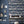 Catwalk wallpaper by Brand McKenzie in blue, animals parading down a city street behind a desk in a home office