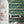 Catwalk wallpaper by Brand McKenzie in teal, animals parading down a city street above a work desk