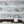 Catwalk wallpaper by Brand McKenzie in pink and blue, pattern detail of animals parading down a city street