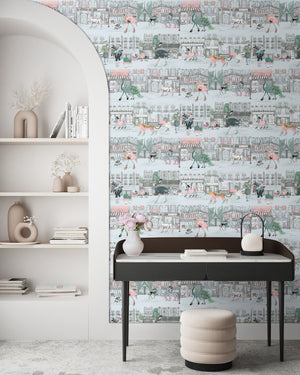 Catwalk wallpaper by Brand McKenzie in pink and blue, animals parading down a city street behind a desk in a home office