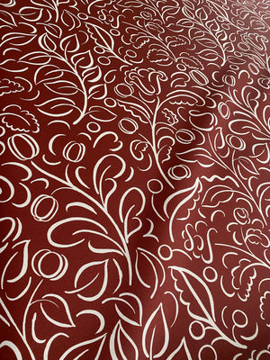 Celeste wallpaper by Claire de Quénetain in red, pattern sample of swirling leaf scrolls