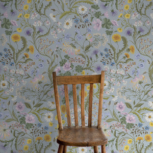 The Lost Garden in Coastal Blue wallpaper by Studio Le Cocq in blue, a dense garden of flowers in a styled room setting