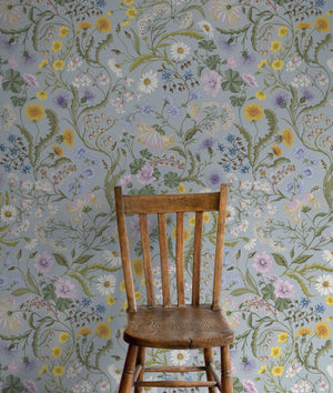 The Lost Garden in Coastal Blue wallpaper by Studio Le Cocq in blue, a dense garden of flowers in a styled room setting