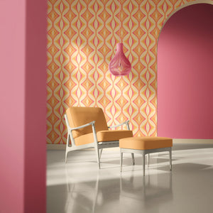 Hourglass wallpaper by Liberty James Studio in orange and pink, a retro hourglass wave behind a sofa in a living room