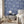 Charming Lanes wallpaper by Brand McKenzie in blue, toile-style townhouses on a bedroom wall