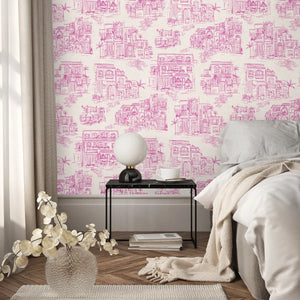 Charming Lanes wallpaper by Brand McKenzie in fuchsia, toile-style townhouses on a bedroom wall