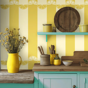 Citrus wallpaper by Liberty James Studio in yellow, wide stripes behind bar stools
