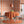 Citrus wallpaper by Liberty James Studio in orange, wide stripes behind a dining table