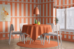Citrus wallpaper by Liberty James Studio in orange, wide stripes behind a dining table