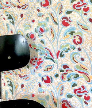 Carmen wallpaper by Claire de Quénetain in yellow and blue, a hand-painted floral design in a styled room setting