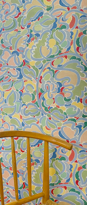 Charlotte wallpaper by Claire de Quénetain in pink and green, a hand-painted floral design in a styled room setting