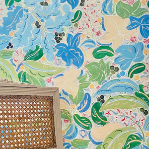 Fabiola wallpaper by Claire de Quénetain in blue and green, a hand-painted floral design in a styled room setting