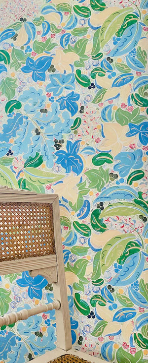 Fabiola wallpaper by Claire de Quénetain in blue and green, a hand-painted floral design in a styled room setting