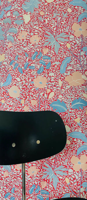 Mafalda wallpaper by Claire de Quénetain in red and blue, a hand-painted floral design in a styled room setting