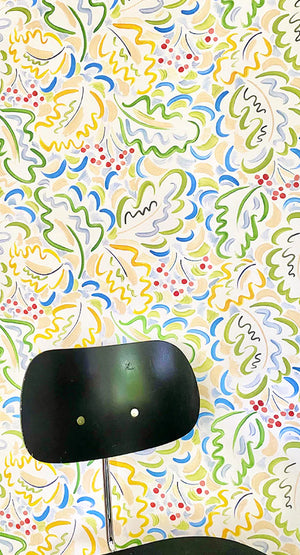 Marianne wallpaper by Claire de Quénetain in yellow and green, a hand-painted floral design in a styled room setting