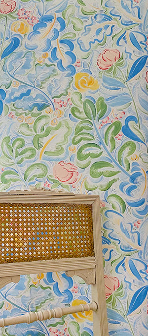 Priscilla wallpaper by Claire de Quénetain in blue and green, a hand-painted floral design in a styled room setting