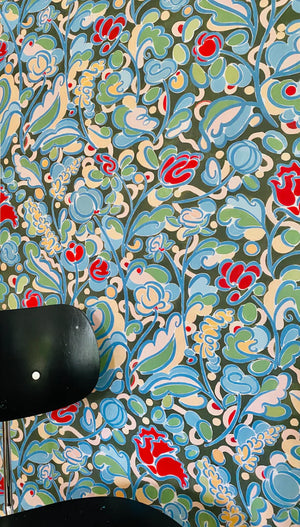 Sybille wallpaper by Claire de Quénetain in green and blue, a hand-painted floral design in a styled room setting