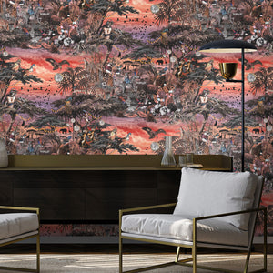 Club Safari wallpaper by Brand McKenzie in orange and pink, a lush safari scene behind a sofa in a living room