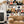 Connecting Frames wallpaper by Brand McKenzie in black and white, a gallery wall of framed portraits in a living room