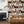Connecting Frames wallpaper by Brand McKenzie in black and white behind a sofa in a living room
