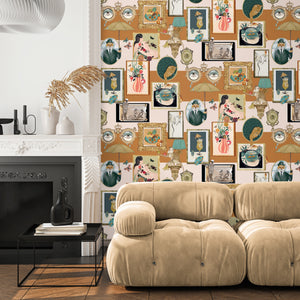 Connecting Frames wallpaper by Brand McKenzie in caramel, a gallery wall of framed portraits behind a sofa in a living room