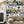 Connecting Frames wallpaper by Brand McKenzie in navy, a gallery wall of framed portraits on a living room wall