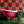 Coral Gables wallpaper by Liberty James Studio in pink, red and green, a bold mirrored floral in a bathroom