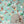 Cosmic Groove wallpaper by Brand McKenzie in aqua, retro figures floating in space around a fireplace