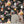 Cosmic Groove wallpaper by Brand McKenzie in charcoal, retro figures floating in space beside a fireplace