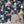 Cosmic Groove wallpaper by Brand McKenzie in navy, retro figures floating in space above a white mantelpiece