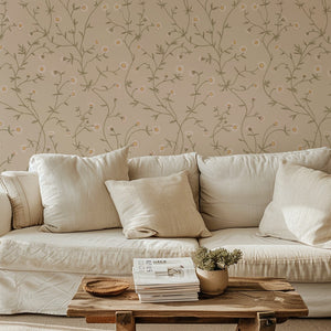 Daisy Chain wallpaper by Studio Le Cocq in cream, trailing daisy chains behind a sofa in a living room