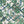 Creeping Trellis wallpaper by Parker and Jules in green and pink, flat sample of flowers on a trellis