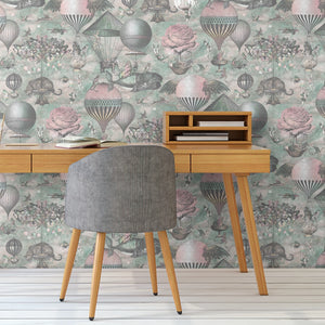 Curious Skies wallpaper by Brand McKenzie in pink and aqua, hot air balloons and creatures in the clouds above a work desk