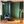 Rubber Plant wallpaper by Annika Reed in navy and green, rubber plant leaves in a living room