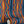 Deco Prism wallpaper by Liberty James Studio in multicolour, partly unrolled roll showing art deco wave stripes