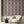 Deco Prism wallpaper by Liberty James Studio in pink, art deco wave stripes on a living room wall