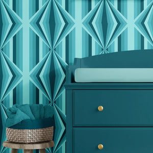 Deco Prism wallpaper by Liberty James Studio in teal, art deco wave stripes behind a console table