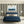 Deco Prism wallpaper by Liberty James Studio in navy and gold, art deco wave stripes in a bedroom