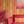 Deco Prism wallpaper by Liberty James Studio in orange, art deco wave stripes in a living room