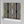 Deco Prism wallpaper by Liberty James Studio in black and gold, partly unrolled roll showing art deco wave stripes