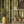 Deco Prism wallpaper by Liberty James Studio in yellow and green, art deco wave stripes above a sideboard