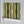 Deco Prism wallpaper by Liberty James Studio in yellow and green, sample roll showing art deco wave stripes