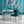 Deco Prism wallpaper by Liberty James Studio in teal, art deco wave stripes in a dining area