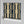 Deco Prism wallpaper by Liberty James Studio in navy and gold, partly unrolled roll showing art deco wave stripes