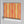 Deco Prism wallpaper by Liberty James Studio in orange, roll showing art deco wave stripes