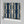 Deco Prism wallpaper by Liberty James Studio in teal and gold, roll showing art deco wave stripes